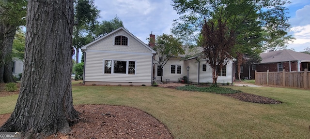 back of property featuring a lawn