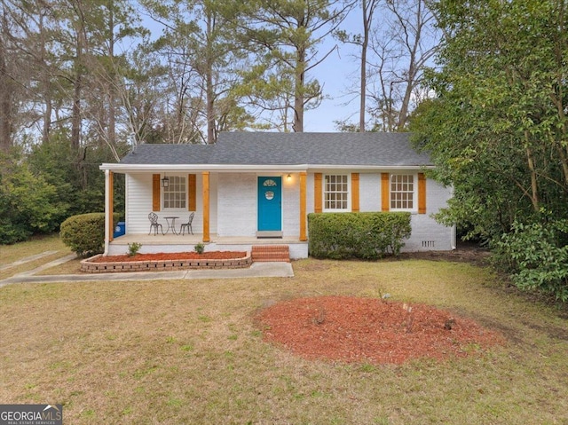 ranch-style home with covered porch and a front lawn