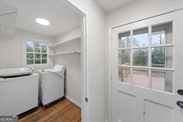 laundry room featuring a wealth of natural light, dark hardwood / wood-style floors, and washing machine and clothes dryer