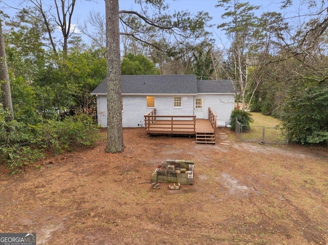 back of house with a deck