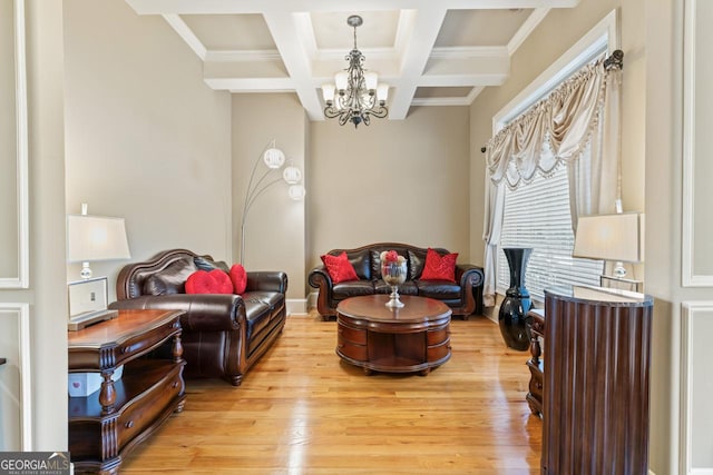 living room with an inviting chandelier, coffered ceiling, light hardwood / wood-style floors, crown molding, and beam ceiling