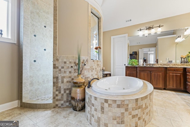 bathroom with independent shower and bath, vanity, tile walls, and tile patterned floors