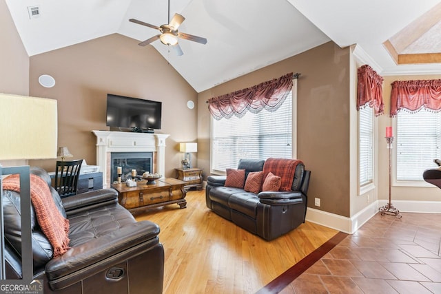 living room featuring ceiling fan, wood-type flooring, and lofted ceiling