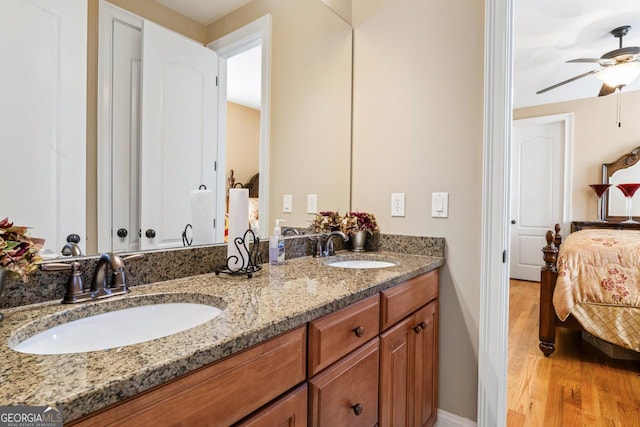 bathroom featuring vanity, hardwood / wood-style floors, and ceiling fan