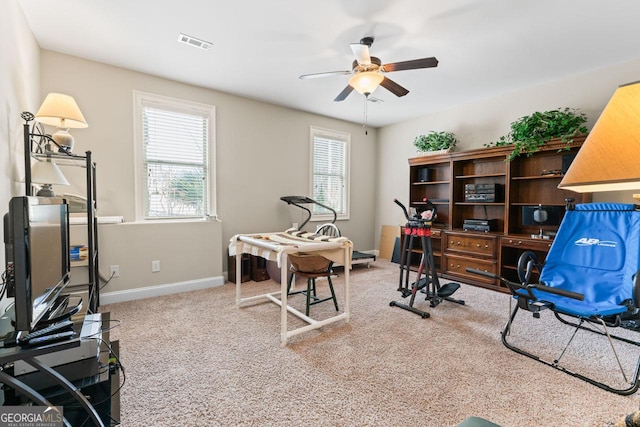 office with carpet floors and ceiling fan