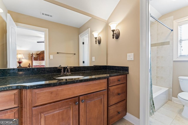 full bathroom with vanity, toilet, tiled shower / bath combo, and tile patterned flooring