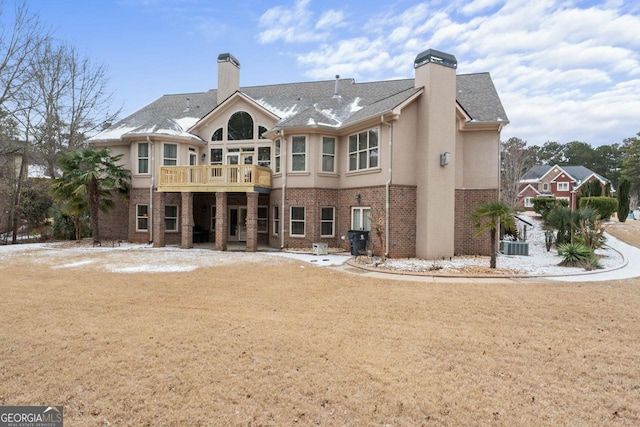 rear view of property featuring cooling unit and a yard