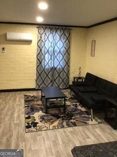 living room with crown molding and hardwood / wood-style floors