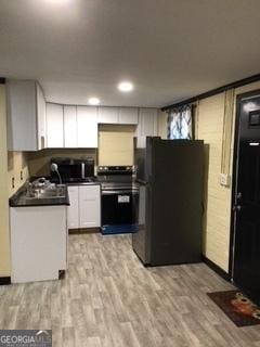 kitchen featuring white cabinetry, appliances with stainless steel finishes, and light hardwood / wood-style floors