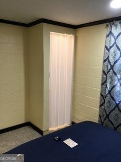 unfurnished bedroom featuring ornamental molding