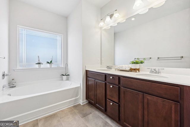 bathroom featuring vanity, a tub to relax in, and tile patterned flooring