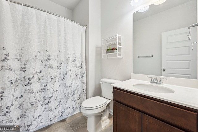 bathroom featuring tile patterned floors, toilet, and vanity