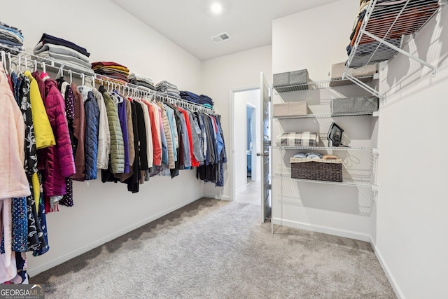 spacious closet with carpet flooring