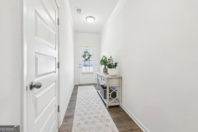 doorway with crown molding and dark hardwood / wood-style flooring