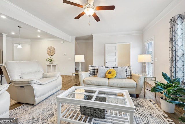 living room featuring crown molding, ceiling fan, and light wood-type flooring