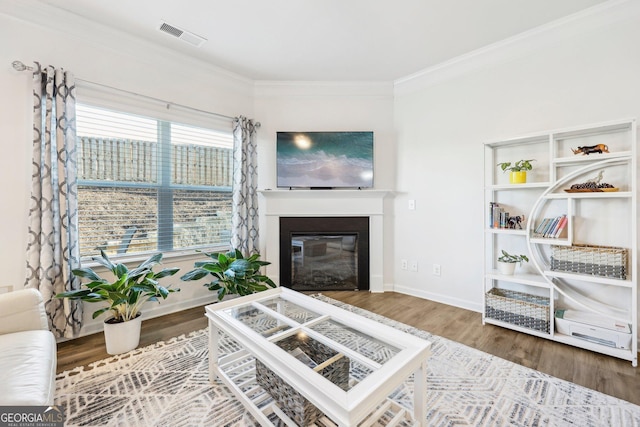 living room featuring hardwood / wood-style flooring and crown molding