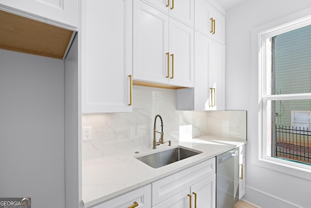 kitchen featuring white cabinetry, sink, and dishwasher