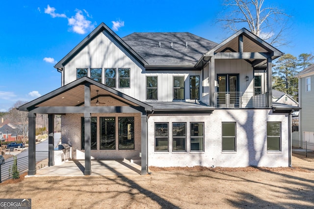 back of property featuring a balcony, ceiling fan, and a patio area