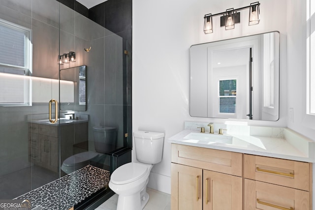 bathroom featuring vanity, tile patterned floors, a shower with door, and toilet