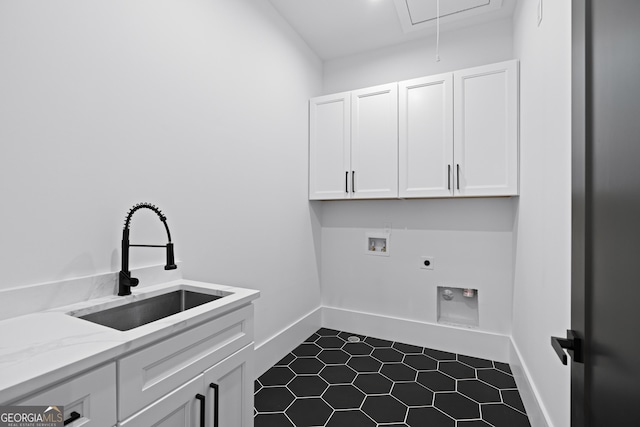 laundry area featuring sink, electric dryer hookup, hookup for a washing machine, cabinets, and tile patterned floors