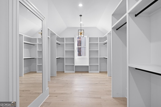 walk in closet featuring lofted ceiling and light hardwood / wood-style floors