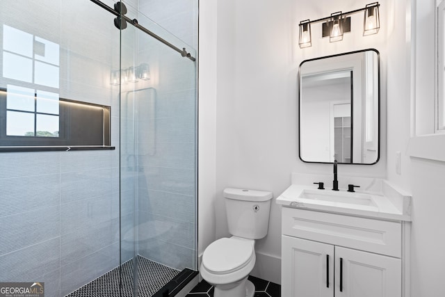 bathroom with vanity, an enclosed shower, and toilet