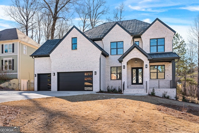 view of front of house with a garage and french doors