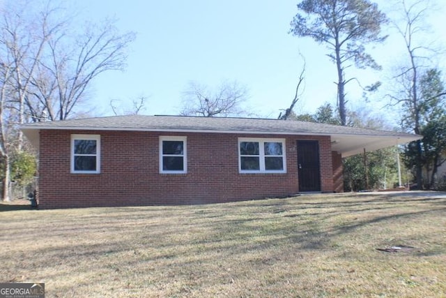 view of front of property with a front lawn and a carport