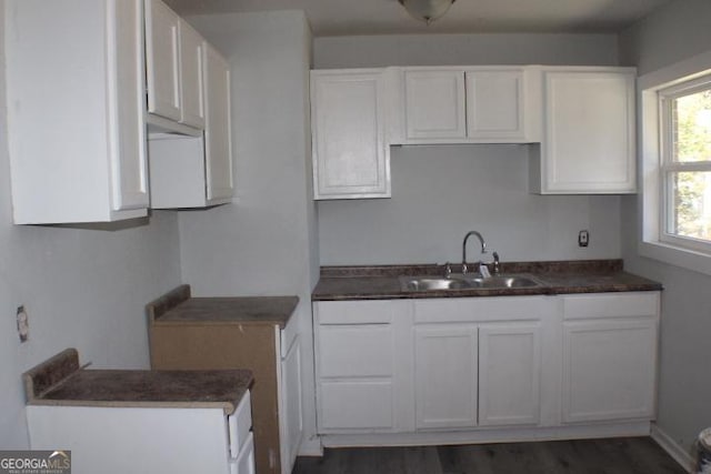 kitchen featuring white cabinetry, sink, and dark hardwood / wood-style flooring