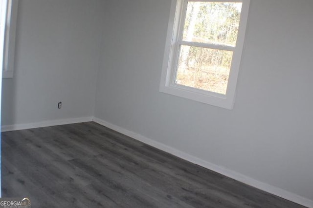 empty room with dark hardwood / wood-style floors