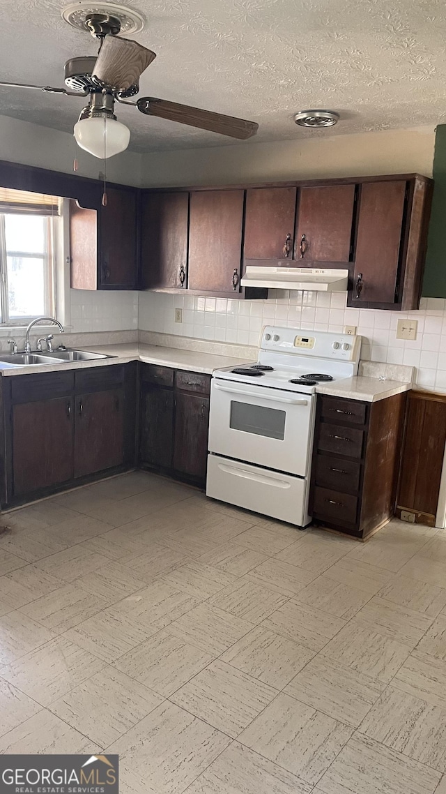 kitchen with sink, white electric range oven, dark brown cabinetry, a textured ceiling, and decorative backsplash