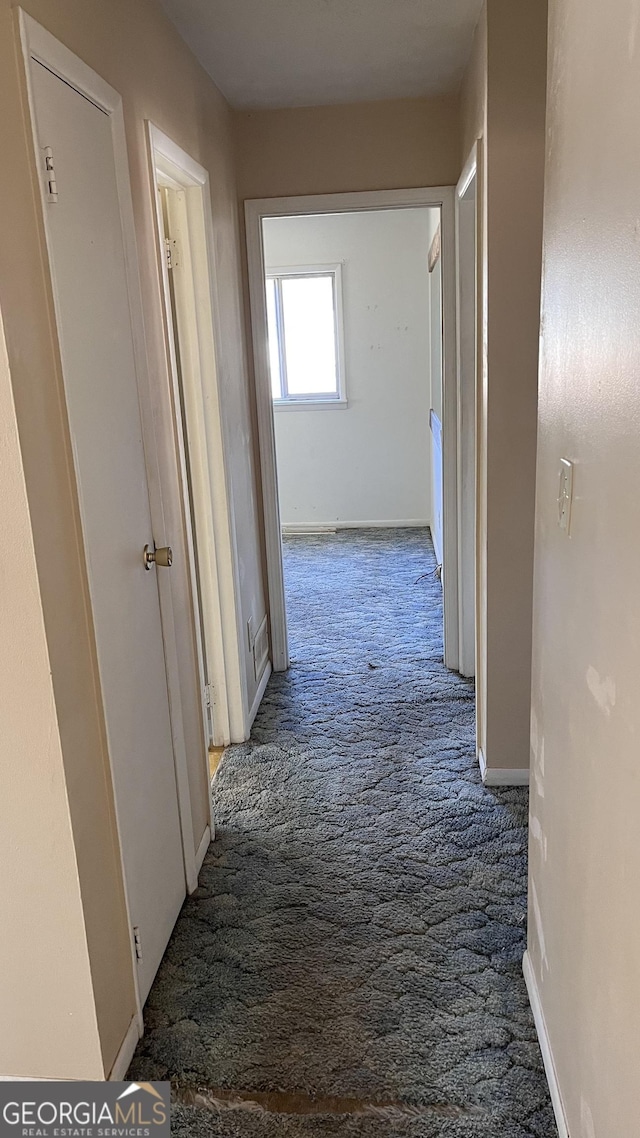 hall with carpet flooring