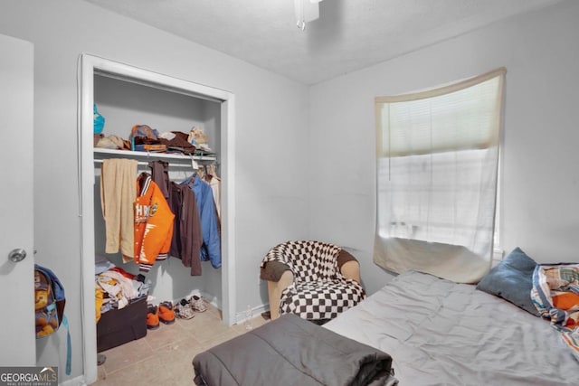 bedroom featuring ceiling fan and a closet