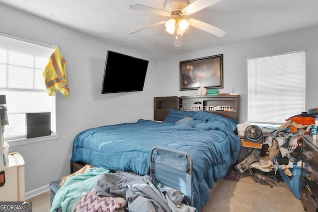 bedroom with multiple windows and ceiling fan