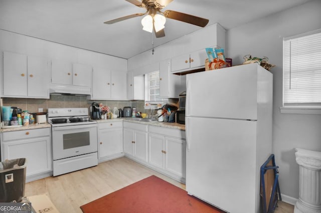 kitchen with white cabinetry, white appliances, light hardwood / wood-style floors, and decorative backsplash