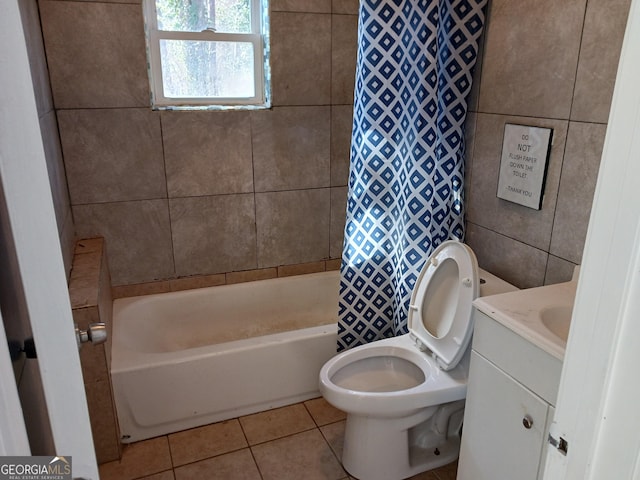 full bathroom featuring tile walls, tile patterned flooring, vanity, toilet, and shower / bath combo with shower curtain