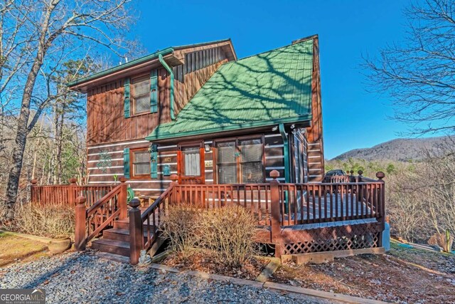 cabin featuring a deck with mountain view