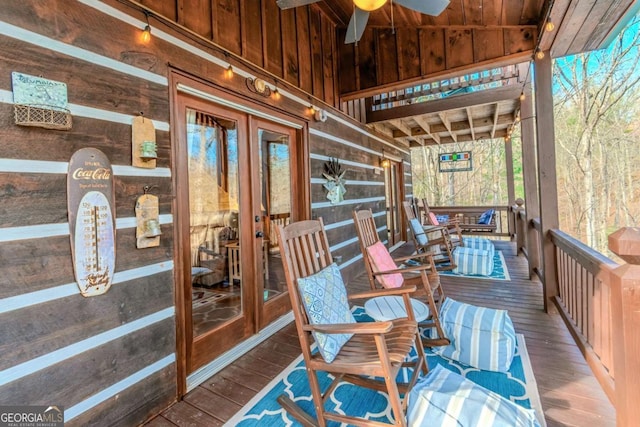 dining space featuring hardwood / wood-style floors, vaulted ceiling, and wood walls