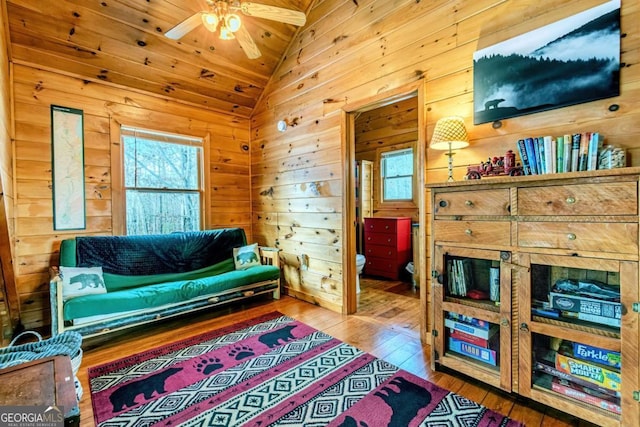 interior space with hardwood / wood-style floors, wooden ceiling, beam ceiling, and wood walls