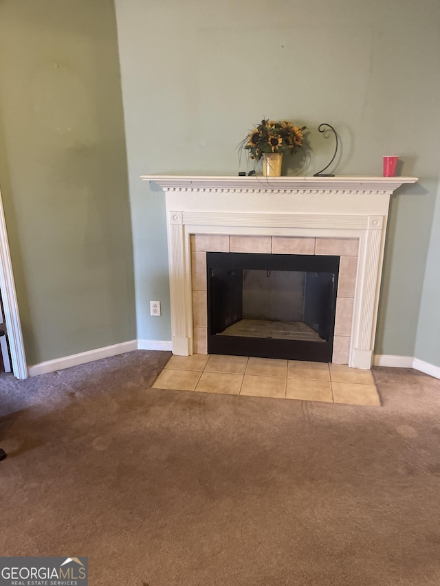 details with a tiled fireplace and carpet