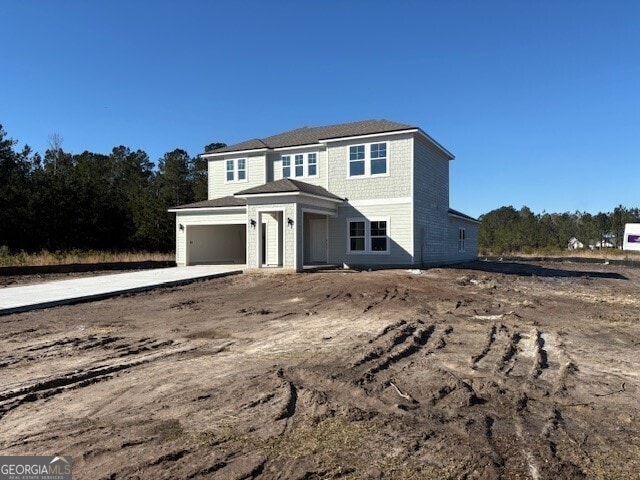 view of front of house featuring concrete driveway and an attached garage