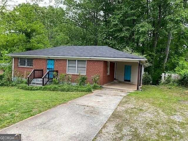 single story home with a carport and a front lawn