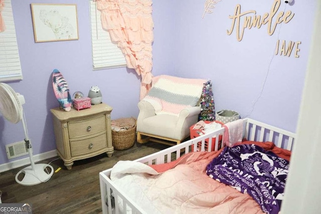 bedroom with dark wood-type flooring