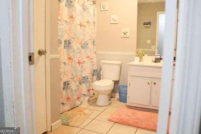 bathroom featuring vanity, tile patterned floors, and toilet