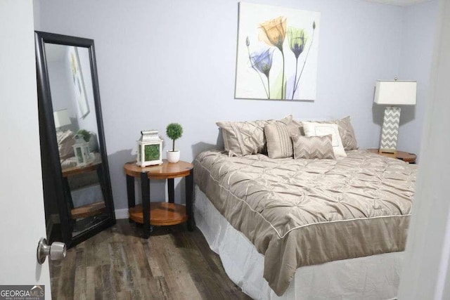 bedroom with dark wood-type flooring