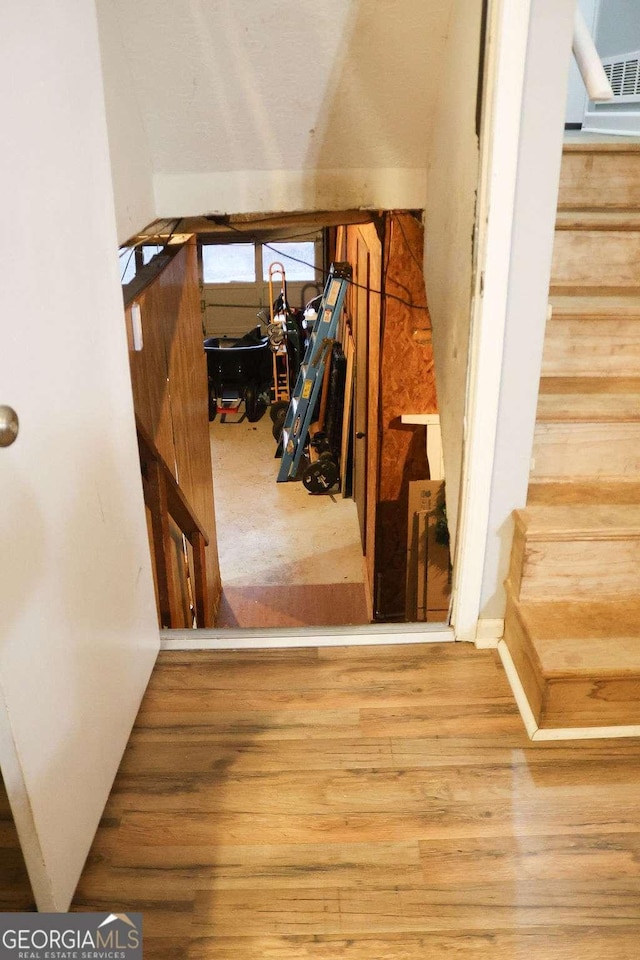 stairway featuring hardwood / wood-style flooring