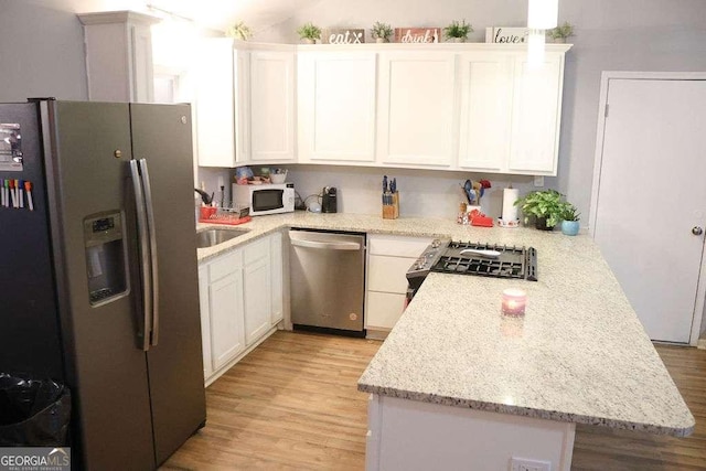 kitchen featuring white cabinetry, light stone countertops, and appliances with stainless steel finishes