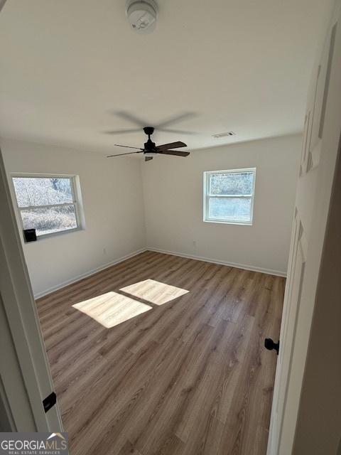 unfurnished room featuring ceiling fan and light wood-type flooring