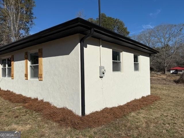 view of property exterior with a yard