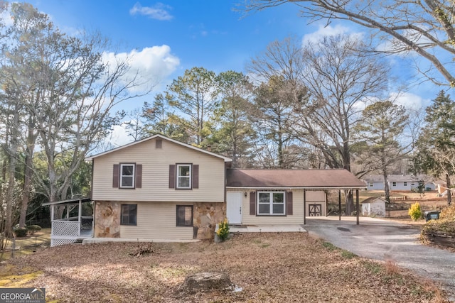 split level home with a carport and a sunroom